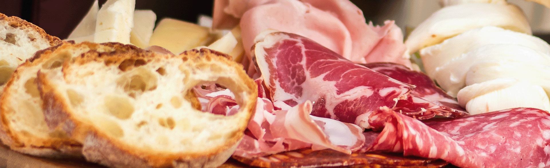 Zoomed in photo of bread, meat, and cheese