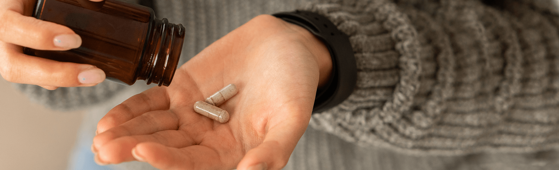 Capsules poured in hand from bottle