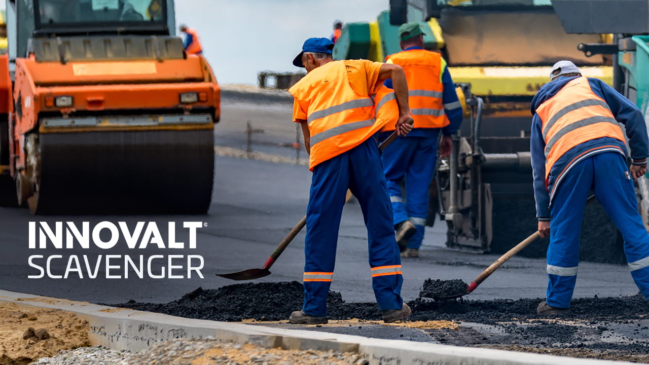 Road workers with paving machinery and INNOVALT SCAVENGER text.