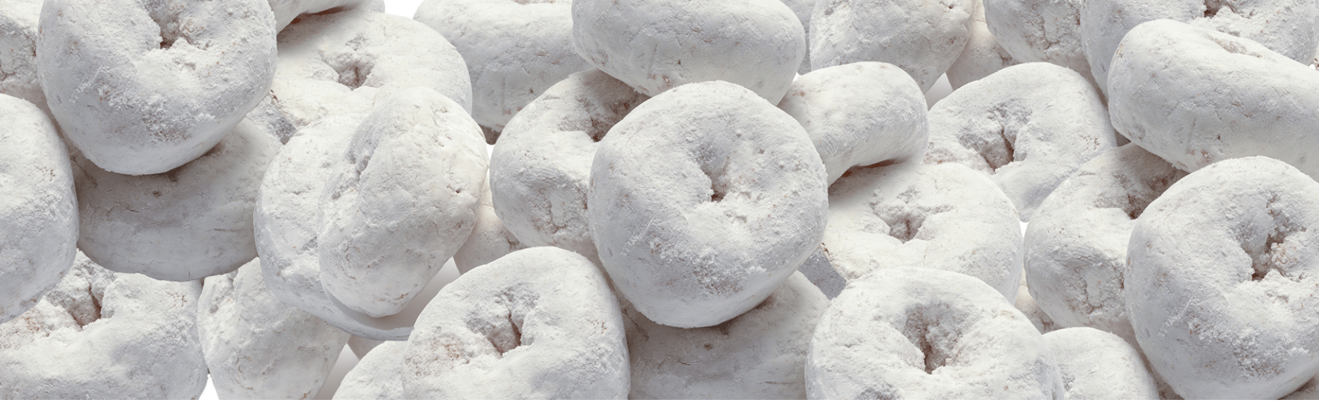 Pile of powdered sugar-coated donuts