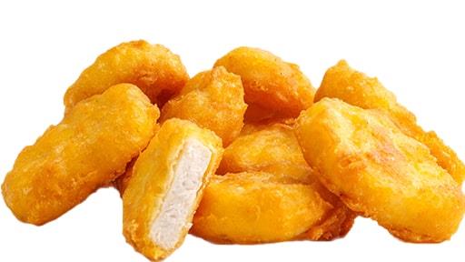 Pile of golden-brown chicken nuggets with one cut open to show white meat