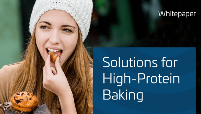Person holding a muffin next to a graphic titled ‘Solutions for High-Protein Baking.