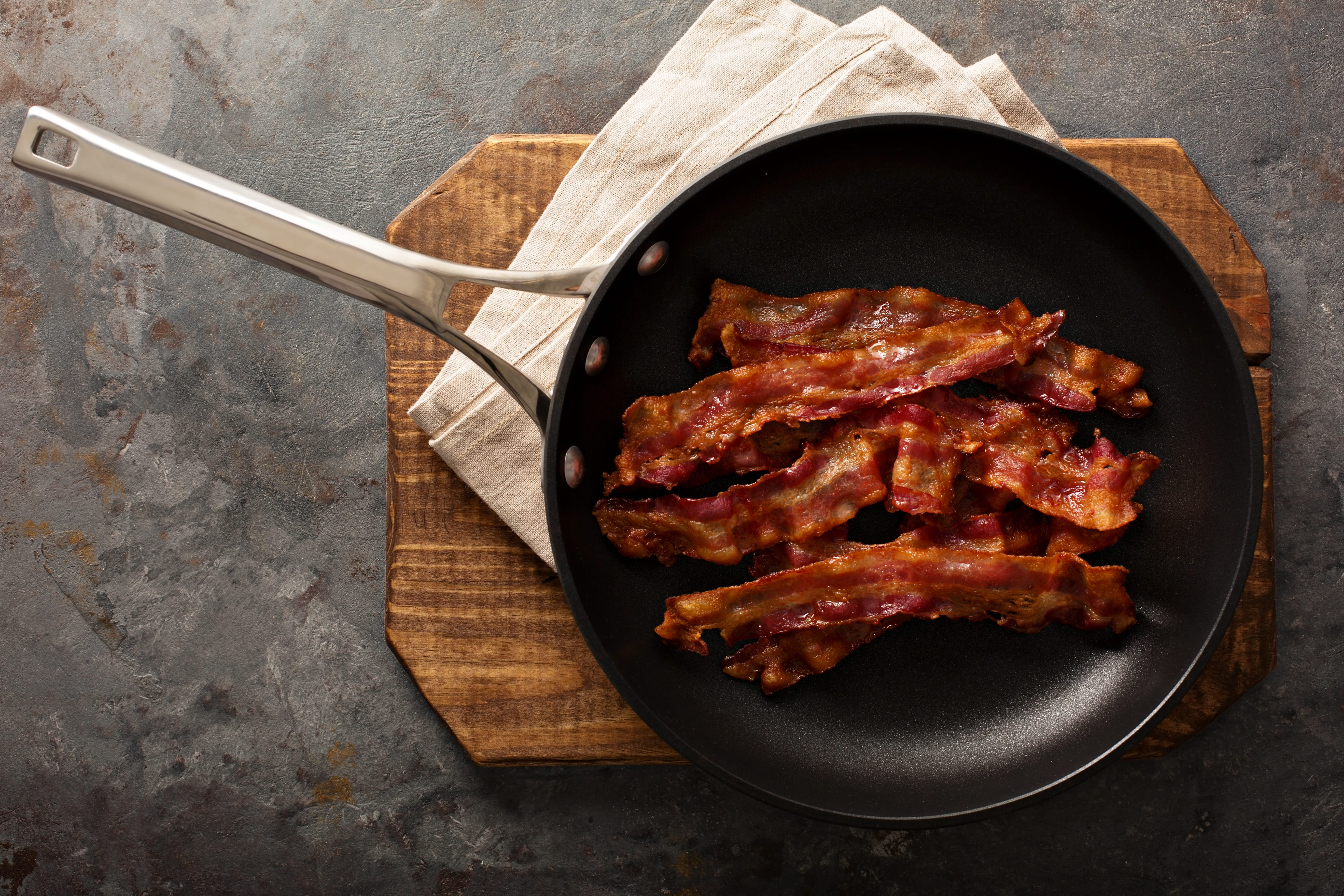 Photo of a sautee' pan filled with crispy bacon.