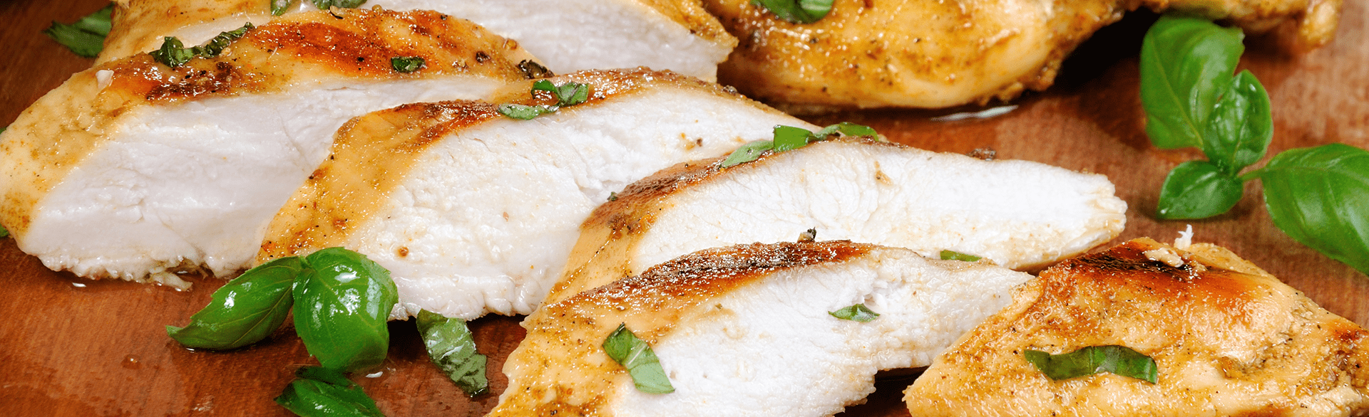 Sliced chicken breast on cutting board