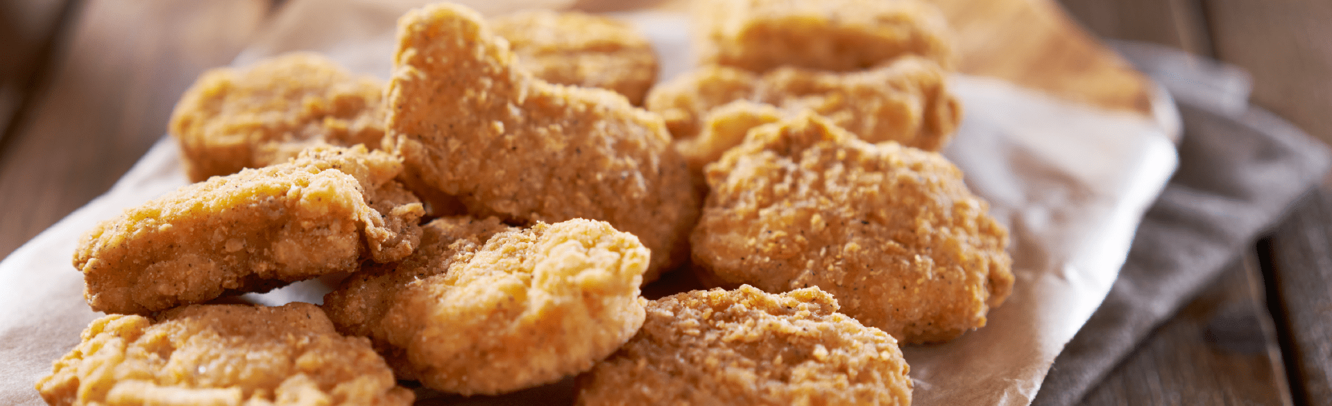 Crispy golden brown chicken nuggets on parchment paper