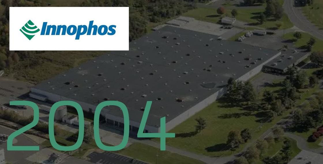 A graphic backdropped by a large commerical building