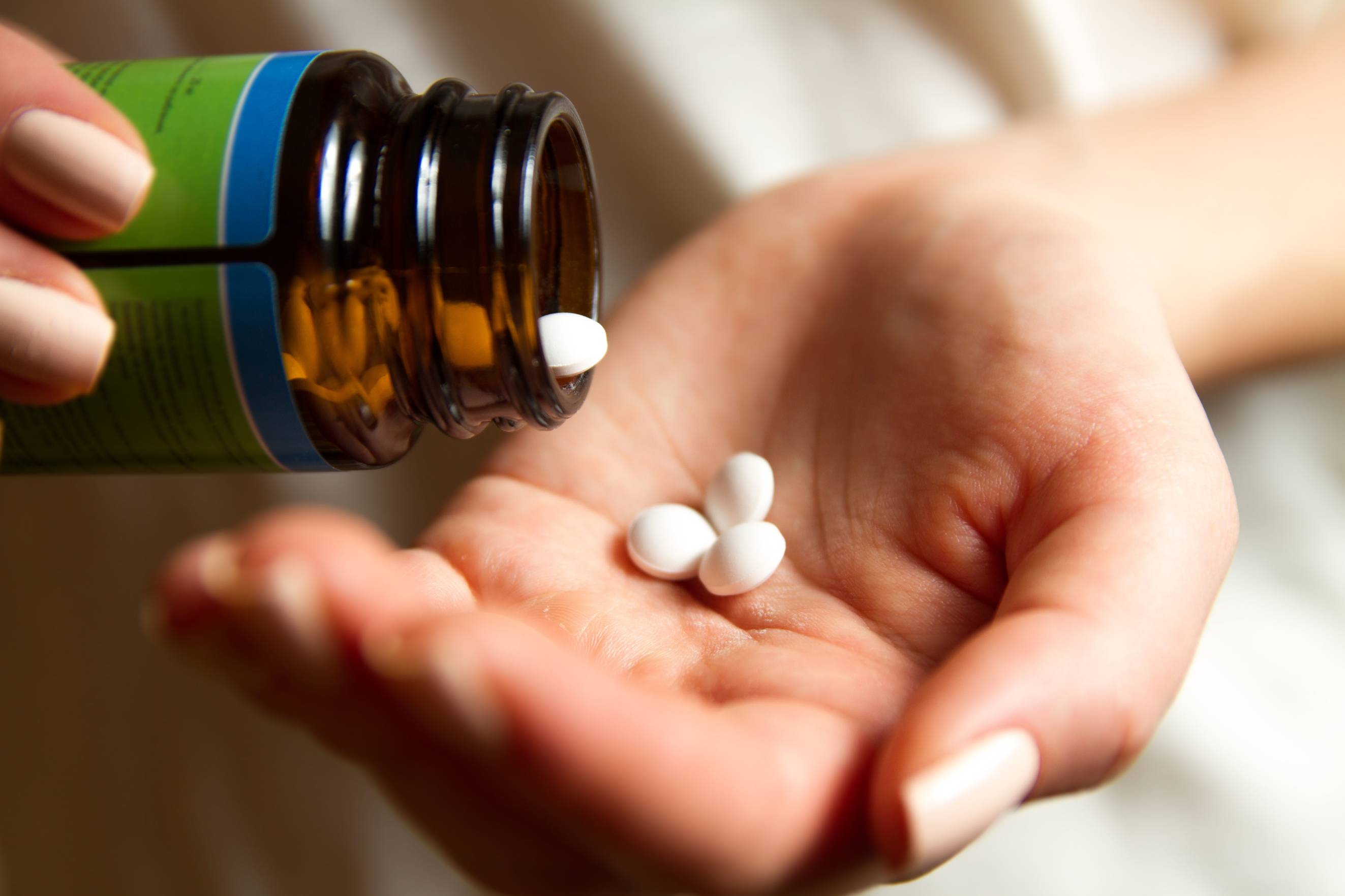 Expanded Partnership with AIC - Hand with Pills