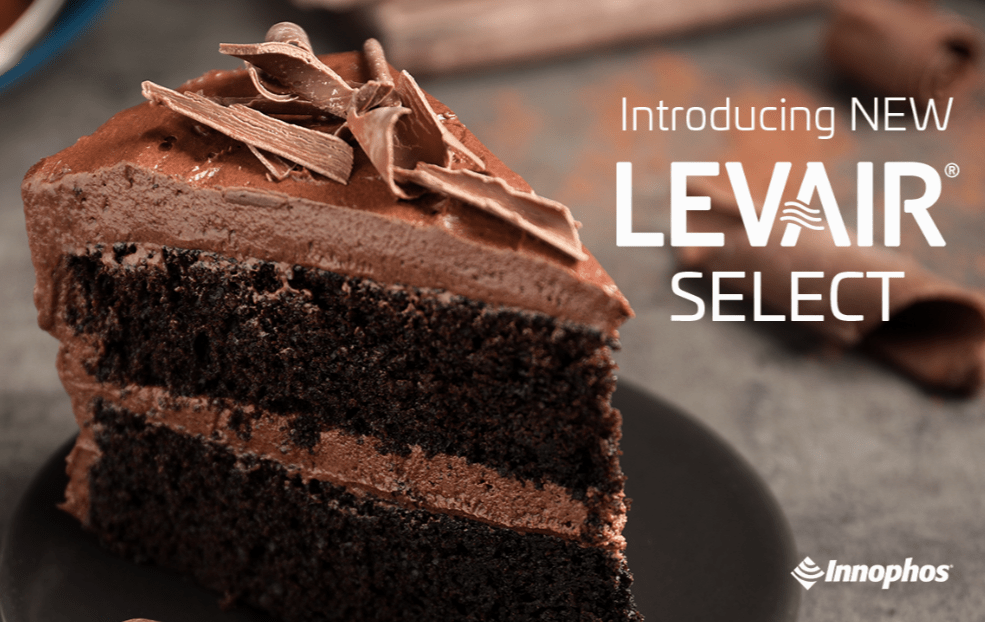 Slice of layered chocolate cake with chocolate shavings, promoting NEW LEVAIR SELECT by ICL Food Specialties