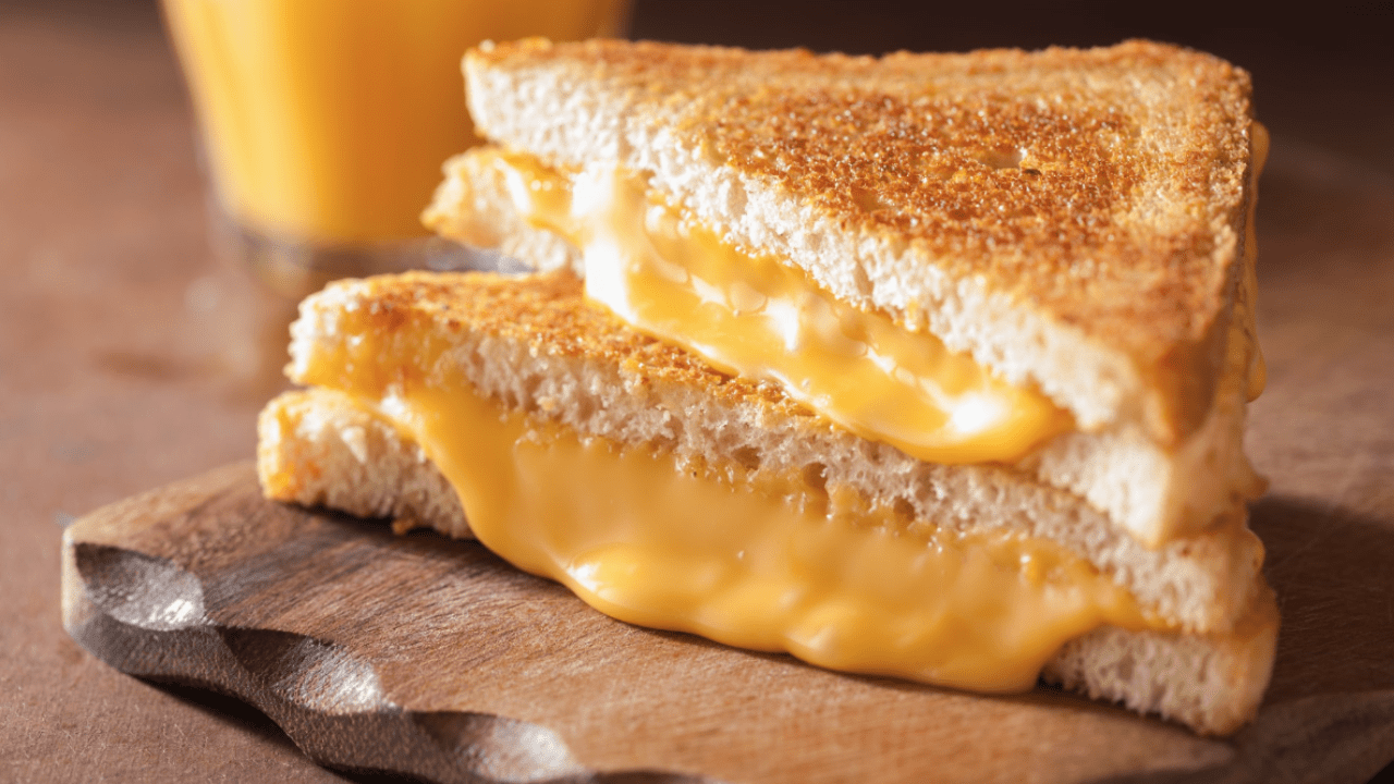 Grilled cheese on a wooden cutting board
