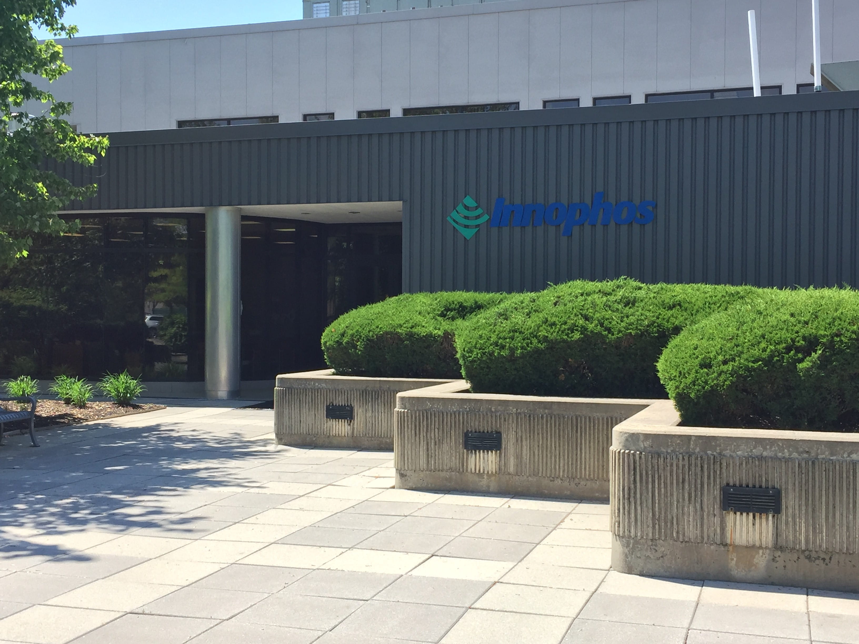 Photo of physical logo of Innophos displayed on wall.