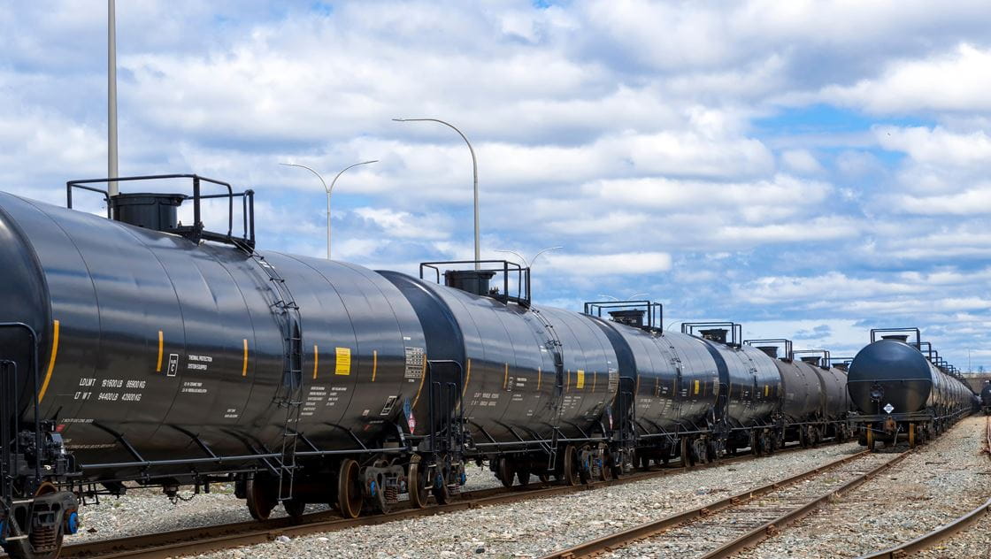 Photo of commercial train cars in motion.